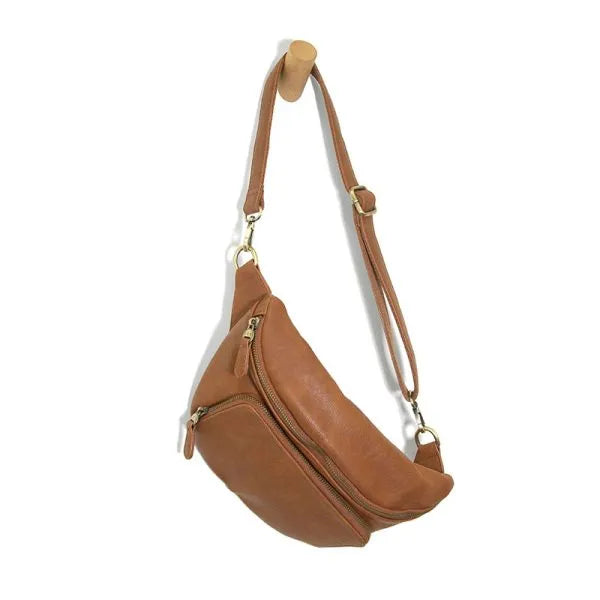 Tan leather rory organizer sling belt bag with gold-tone zippers and hardware featuring a belt bag design