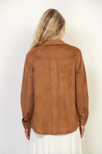 A tan suede classic western shacket with a classic collar and buttoned cuffs in a classic western style