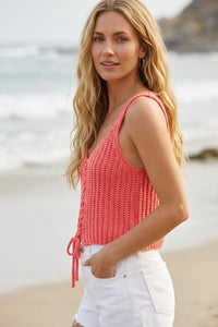 Coral-colored knitted tate laceup sweater tank with sleeveless design and tie-side detail for casual wear