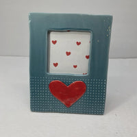 Teal stoneware heart icon ceramic picture frame with textured surface featuring large and small red hearts on white background