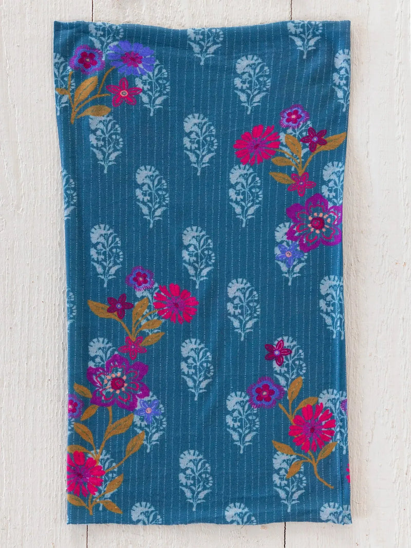 Teal cotton tea towel with vibrant floral pattern of pink purple gold blossoms and white botanical motifs in block stamp indigo boho bandeau headband style