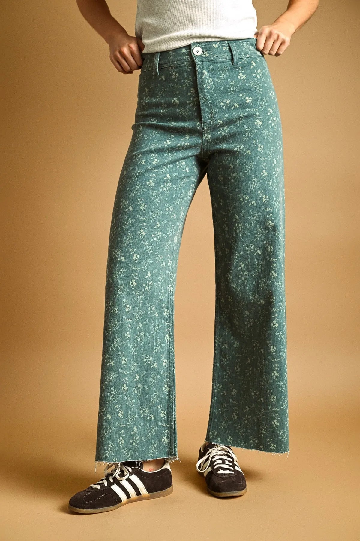 Teal floral print stretched wide leg pants with denim material and frayed hem for a stylish casual look