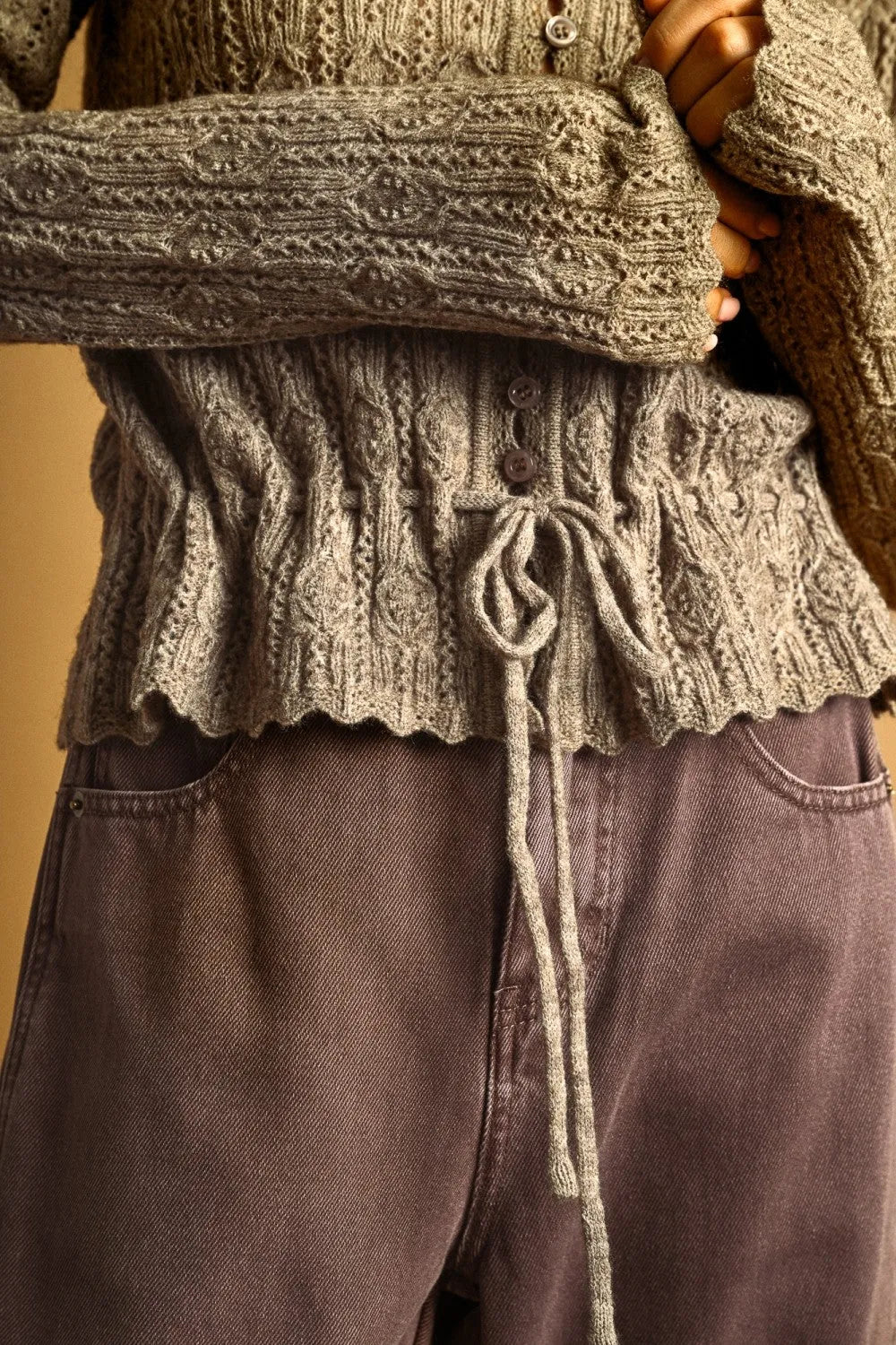 Textured muted olive-green lace knit waist knit cardigan with intricate cable patterns and drawstring waistband