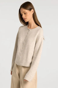 A soft light beige knitted cardigan with round neckline and button closure from supply Dover button collection