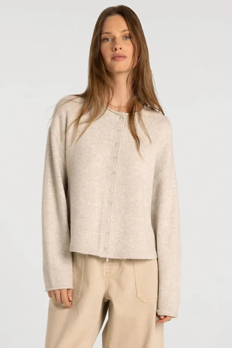A soft off-white knit supply dover button cardigan with a button-front closure and relaxed fit