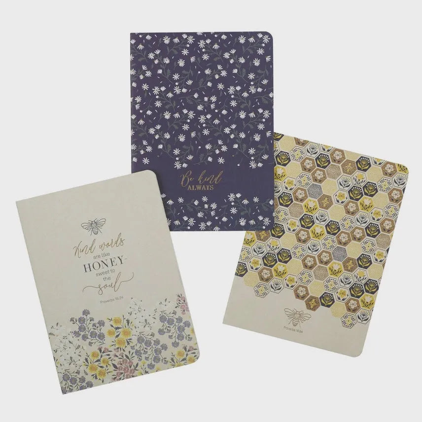 Notebook set of 3 kind words featuring honey-themed pastel covers with floral and hexagonal patterns for women’s boho chic clothing fans