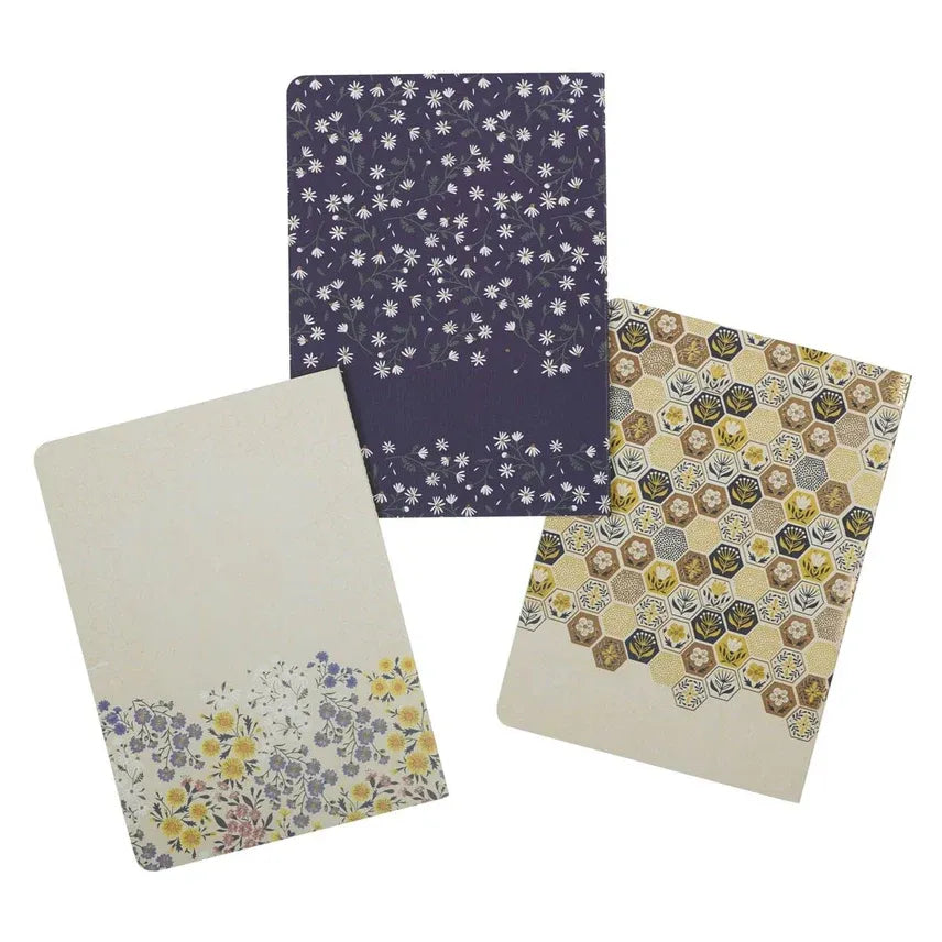 Notebook set of 3 kind words featuring floral and hexagonal patterns in muted purple beige yellow and green for women’s boho chic clothing fans