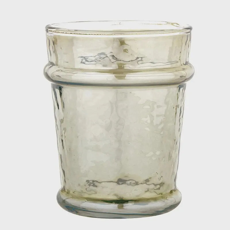 A translucent textured everyday luster glass candle holder with amber tint and ridged bands in green
