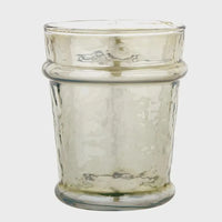 A translucent textured everyday luster glass candle holder with amber tint and ridged bands in green