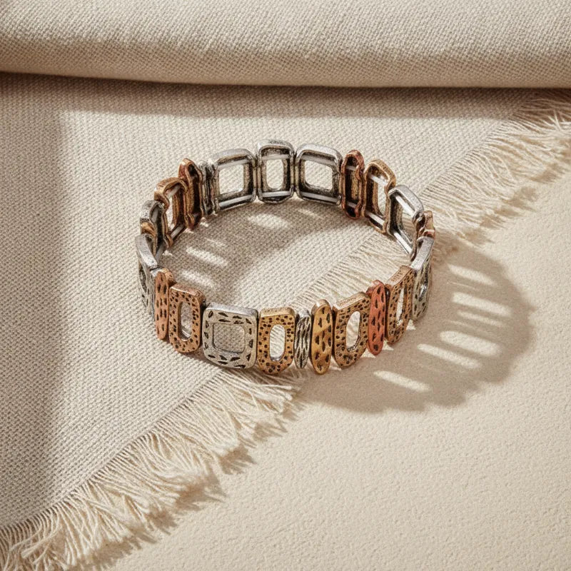 Elegant artisanal textured stretch statement bracelet with alternating silver and rose gold cut-out square links