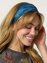 A vibrant blue tie-dye fabric boho bandeau headband with a soft texture in navy patchwork design