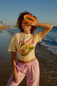 Off-white crew neck graphic t-shirt featuring a bold sliced papaya design with pink papayas lettering across the chest