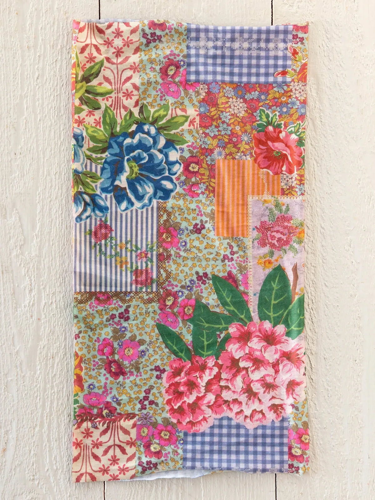 A vibrant boho bandeau headband in vintage treasure pink featuring floral and gingham patchwork fabric patterns