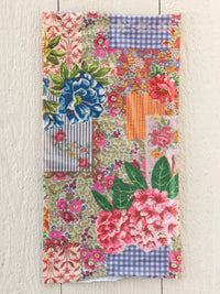 A vibrant boho bandeau headband in vintage treasure pink featuring floral and gingham patchwork fabric patterns
