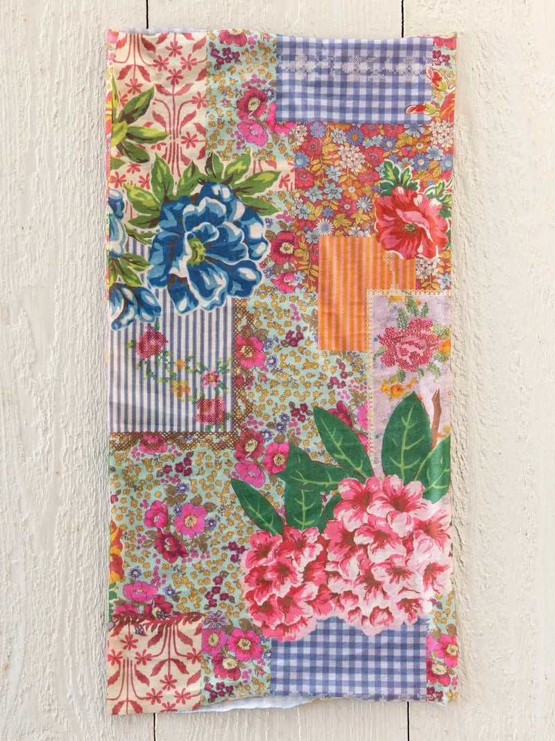 A vibrant boho bandeau headband in vintage treasure pink featuring floral and gingham patchwork fabric patterns