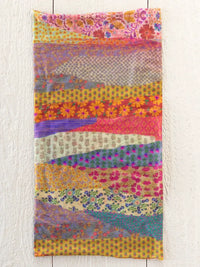 A vibrant boho bandeau headband full of garden waves patterns in bright floral and geometric patchwork colors