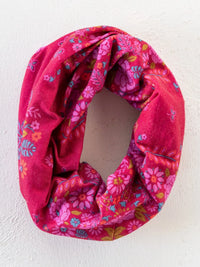 A vibrant pink floral boho bandeau headband with soft textured fabric and colorful blossoms in merlot bandana style