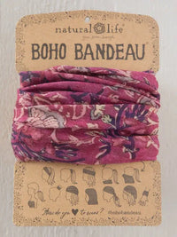 A vibrant pink floral-patterned boho bandeau headband neatly folded on branded natural life packaging