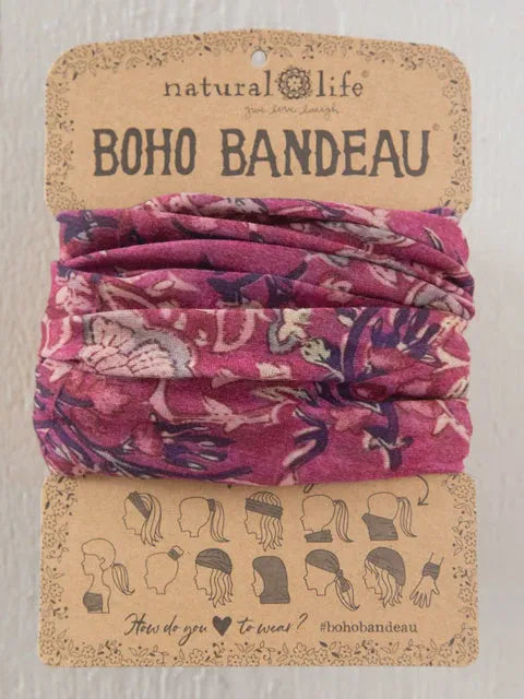 A vibrant pink floral-patterned boho bandeau headband neatly folded on branded natural life packaging