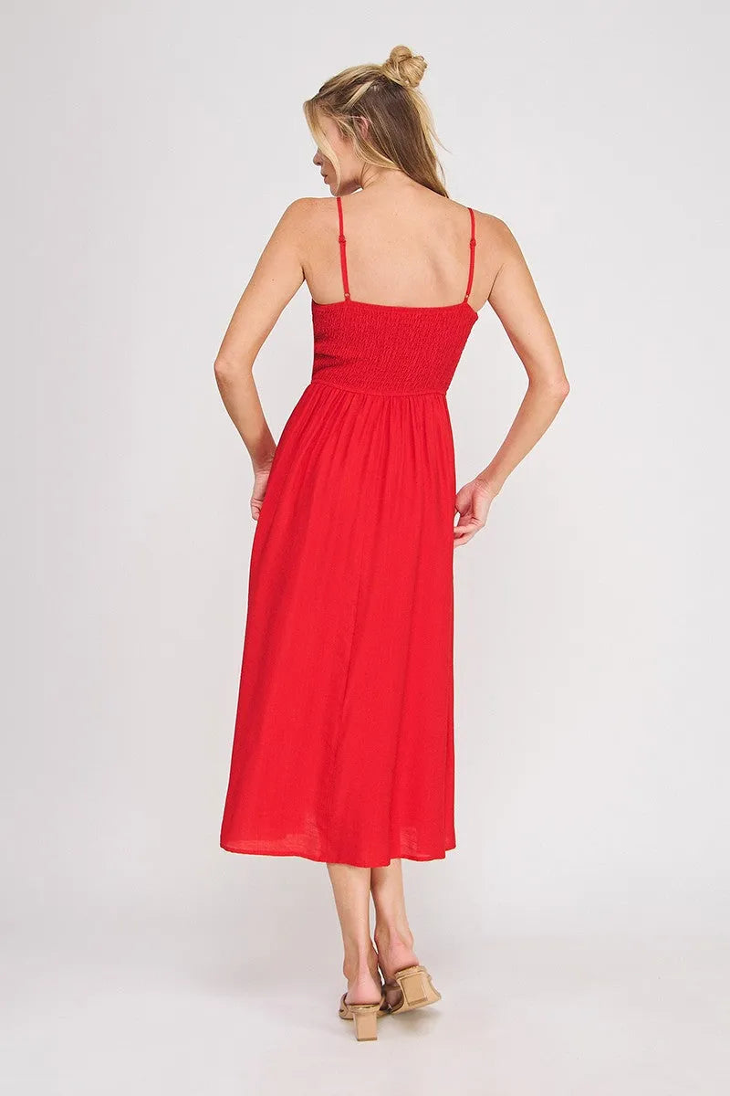 A vibrant red sleeveless midi dress with a smocked bodice and thin straps, perfect as a bodice maxi dress