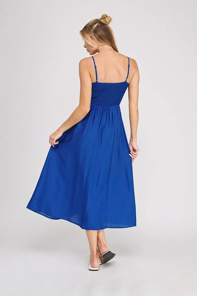 A vibrant royal blue sleeveless midi bodice maxi dress with a smocked bodice and delicate spaghetti straps