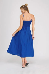 A vibrant royal blue sleeveless midi bodice maxi dress with a smocked bodice and delicate spaghetti straps