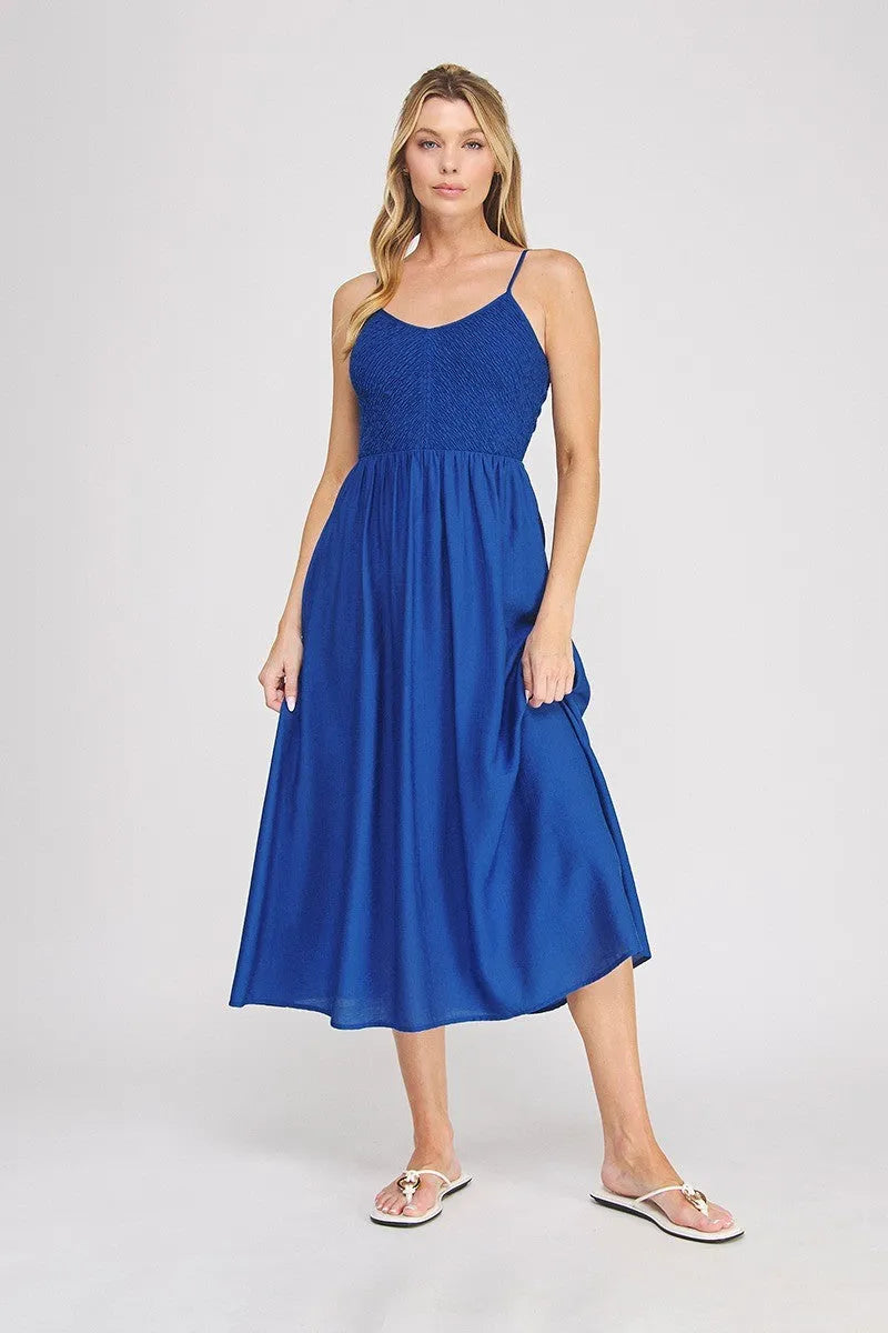A vibrant royal blue sleeveless midi dress featuring a smocked bodice and flowing skirt in a bodice maxi style