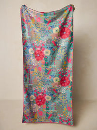 A vibrant double sided microfiber beach towel with a sheer floral pattern in pink red and teal favorite color design