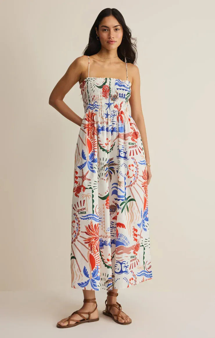 A vibrant sleeveless cornelia getaway maxi dress with colorful red blue and green tropical botanicals on white background