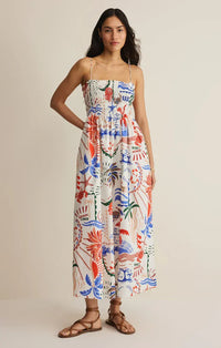 A vibrant sleeveless cornelia getaway maxi dress with colorful red blue and green tropical botanicals on white background