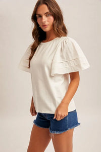 White wing sleeve blouse with flutter sleeves and delicate eyelet stitching perfect for elegant gatherings
