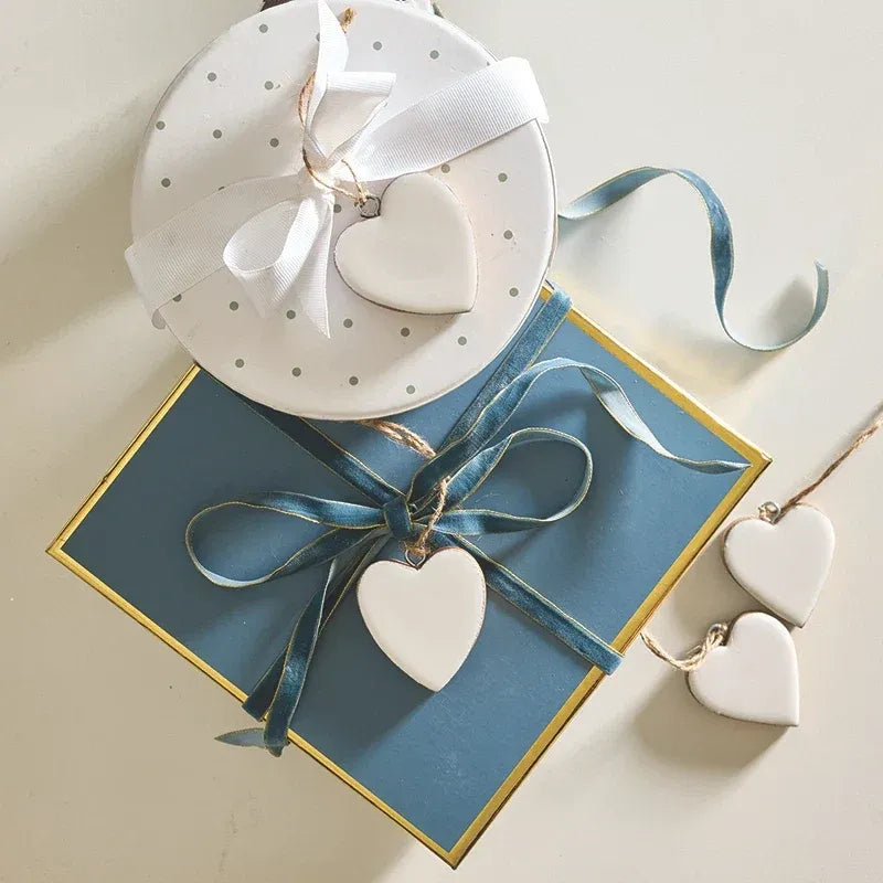 White ceramic enamel wood heart ornament with smooth matte finish and heart-shaped design for decorative use
