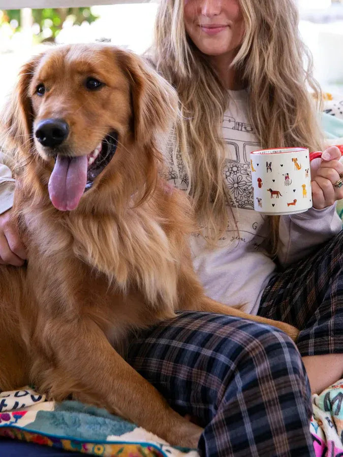 White ceramic bungalow mug with red rim and colorful dog illustrations from shop daisy inspired by women’s boho chic clothing