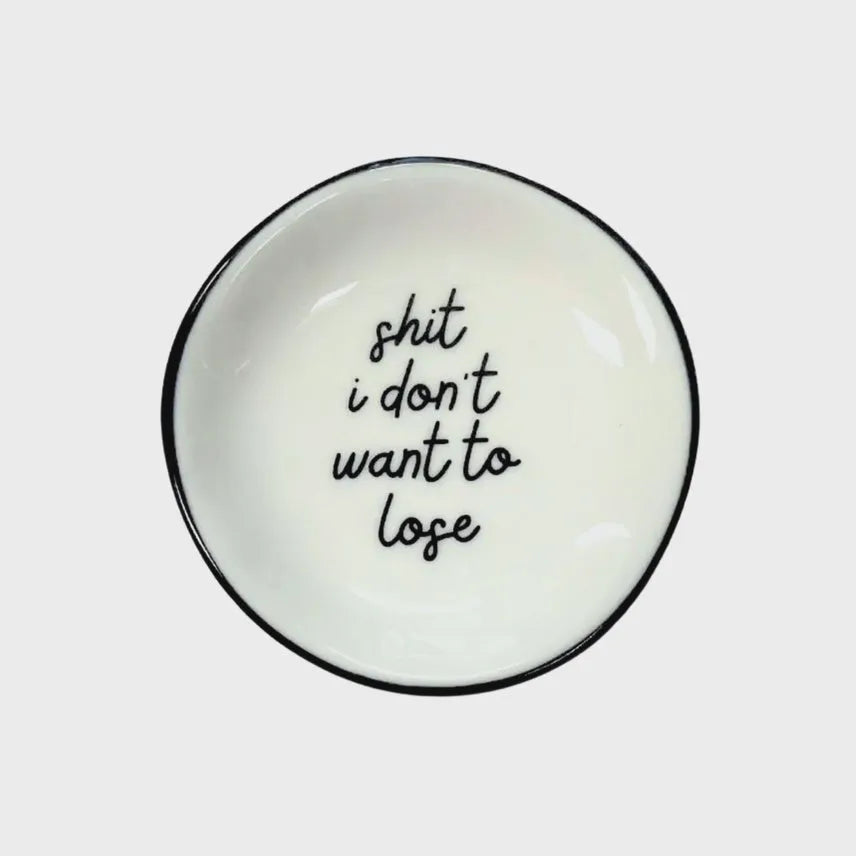 White ceramic ring dish with black rim and shit i dont want to lose phrase in black cursive script for shop daisy women’s boho chic clothing