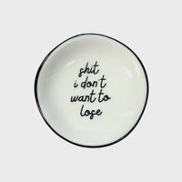 White ceramic ring dish with black rim and shit i dont want to lose phrase in black cursive script for shop daisy women’s boho chic clothing