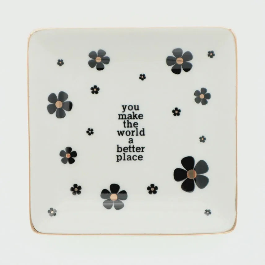 White ceramic trinket tray with black floral decals and gold rim featuring you make the world a better place text, shop daisy