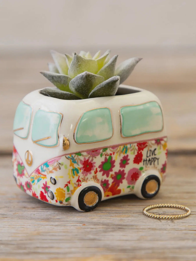 White ceramic van-shaped planter with mint green windows and live happy floral pattern holding tiny faux succulents