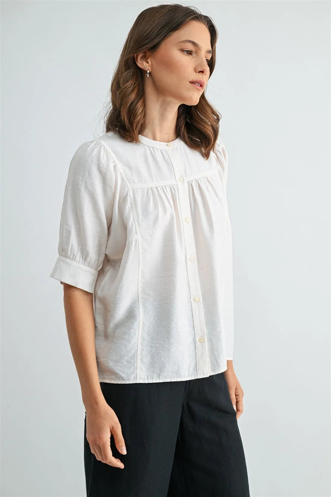 White cotton button down short sleeve blouse with puffed sleeves featuring a classic button front design