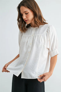 White cotton short sleeve blouse with puffed short sleeves and button-down front for elegant wear