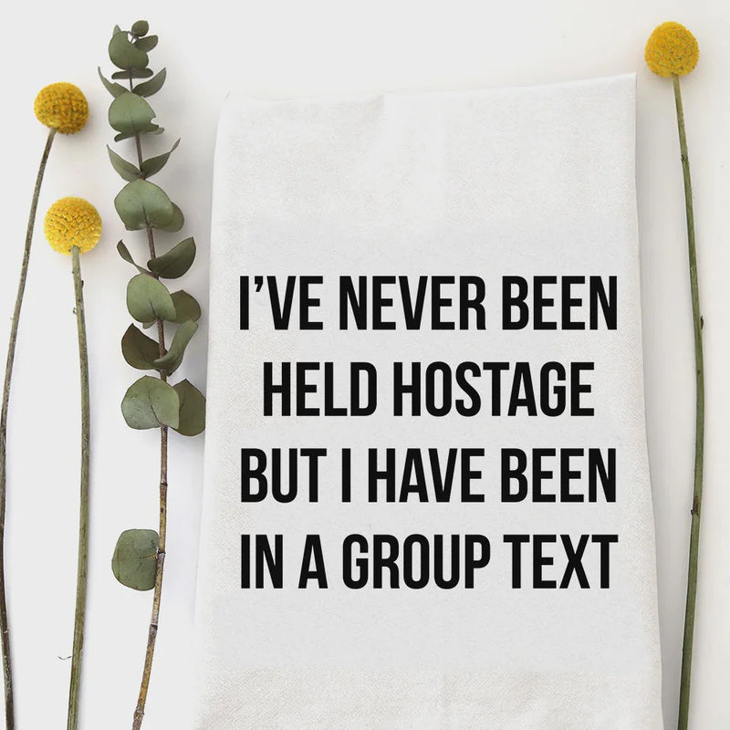 White cotton held hostage kitchen tea towel with bold black text