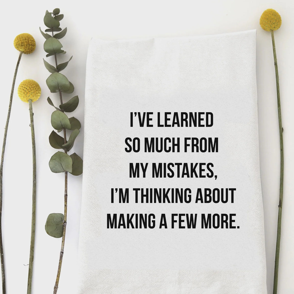 White cotton kitchen tea towel with humorous quote on mistakes