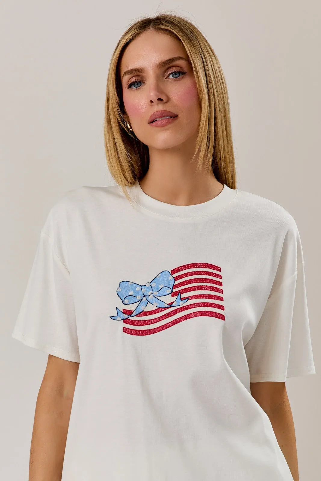 White round neck cotton t shirt with usa flag graphic in red and blue sequins and bow detail