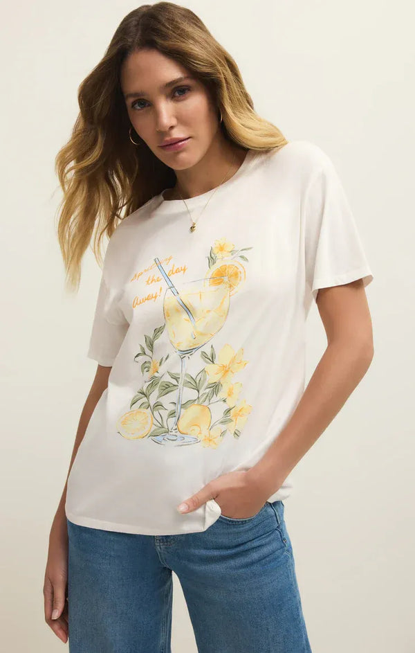 White cotton spritz boyfriend tee featuring vibrant lemonade illustration with yellow lemons flowers and orange script text