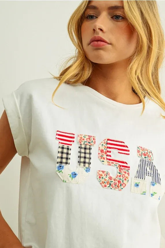 White cotton t shirt with usa floral patchwork design featuring red white and blue floral patterns on front