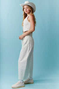 White cowboy hat with subtle stitching details paired with high waist mini bow print waist tie barrel denim