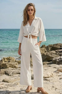 White cropped button-up shirt with delicate lace sleeves paired with linen blend soft hand feel relaxed wide leg pants