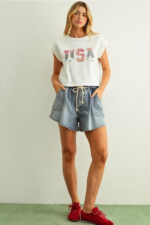White cropped sleeveless top with usa floral patchwork red white and blue sequin lettering front design