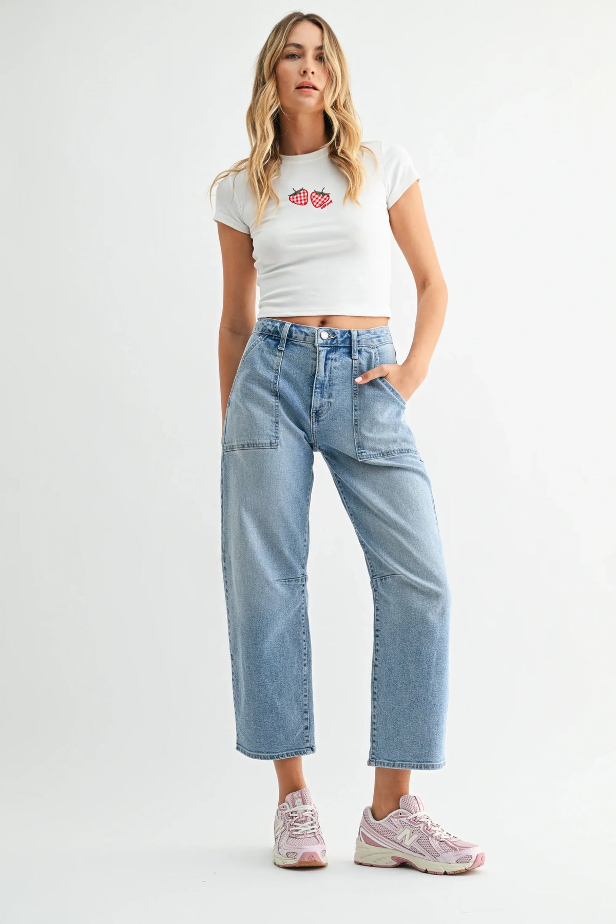 White cropped t-shirt with embroidered red strawberries paired with mid rise utility seamed barrel jean