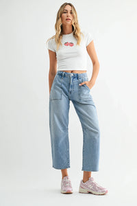 White cropped t-shirt with embroidered red strawberries paired with mid rise utility seamed barrel jean