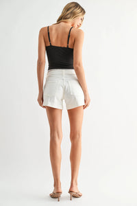 Low rise slit lightweight short in white denim with black straps and a fitted waistband for casual wear